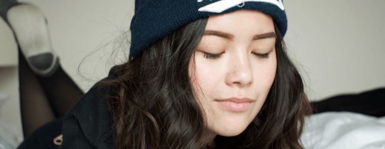 facials for teens: Teenaged girl wearing New York toque with eyes closed