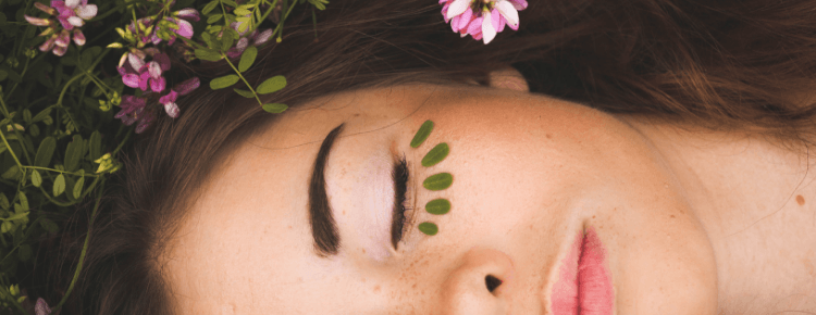 vegan skincare: woman with leaves under her eye, like eyelashes